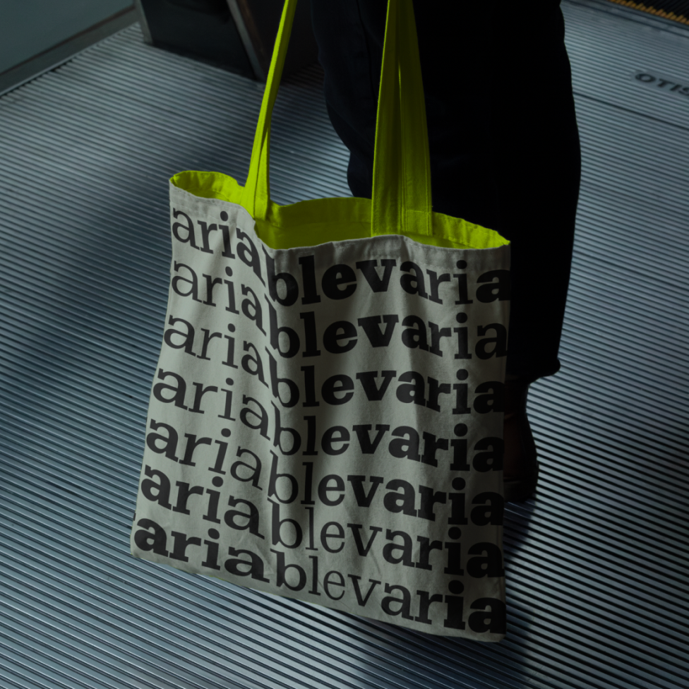 Graphic of a typography specimen showing the alphabet and numerals on top of a dark gray background.